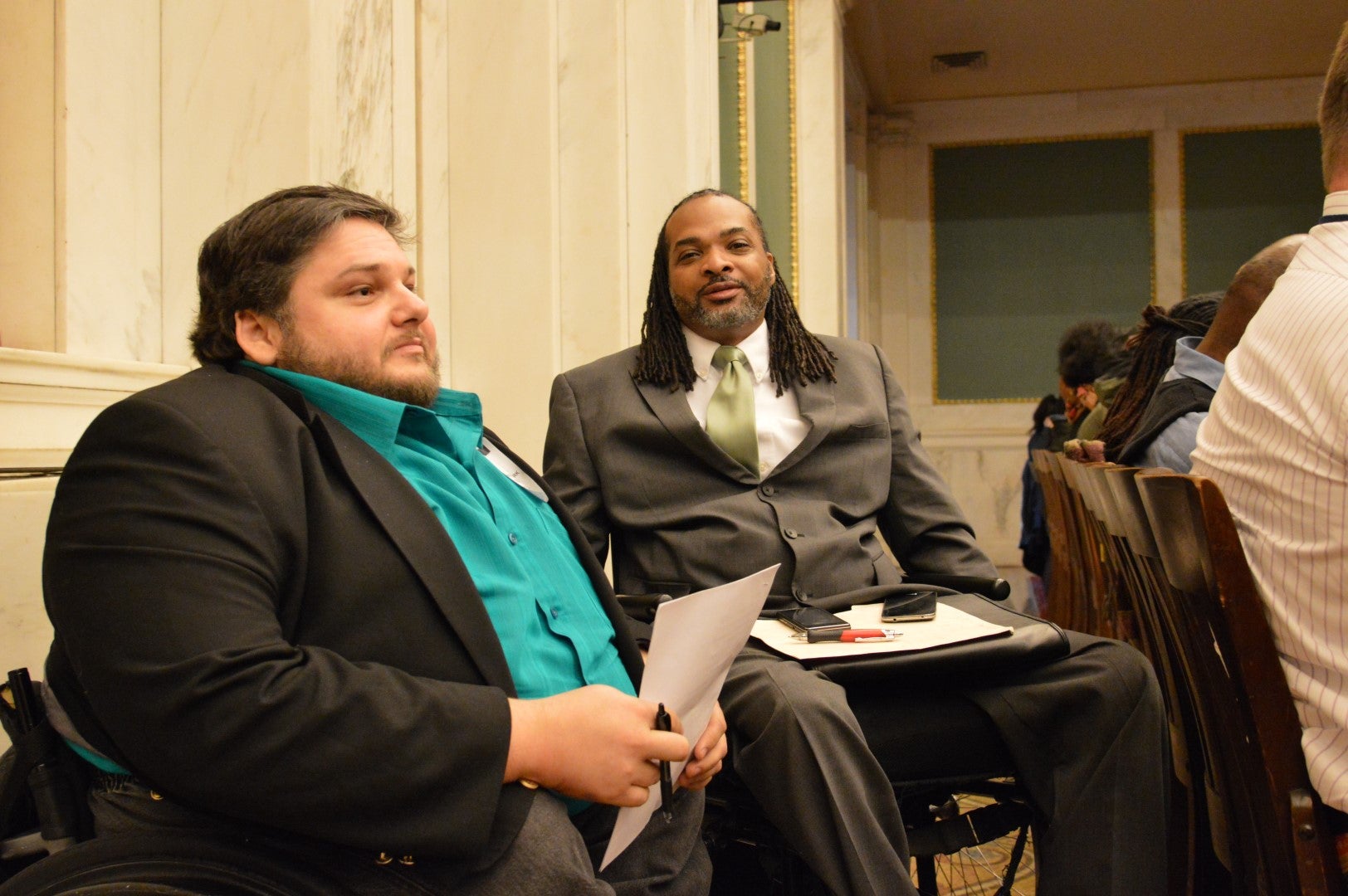Charles Horton and Matt Clark talk during City Council hearing on funding for the city's commission on disabilities.  (Tom MacDonald