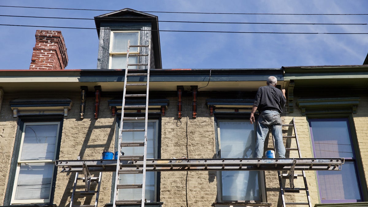  David McCloud restores an aging home in the Mexican War Streets district of Pittsburgh, Pa. New research by the Federal Reserve's Philadelphia office shows a vast majority of lower-income households in Pennsylvania spend more than the conventionally-advised one third of income on housing. (Lindsay Lazarski/WHYY) 