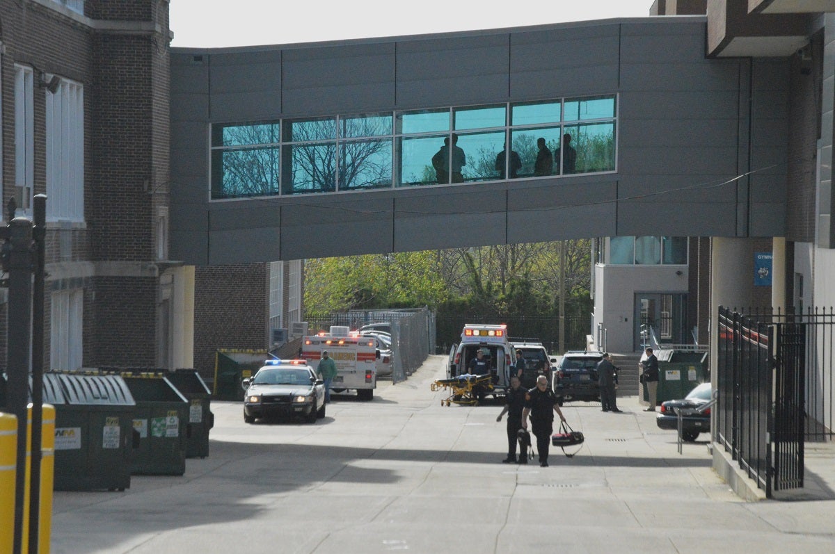 Paramedics walk outside Howard High School April 21st. (John Jankowski/for NewsWorks)