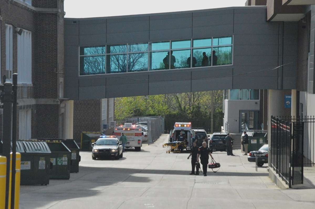 Paramedics walk outside Howard High in Wilmington Thursday morning. (John Jankowski/for NewsWorks)