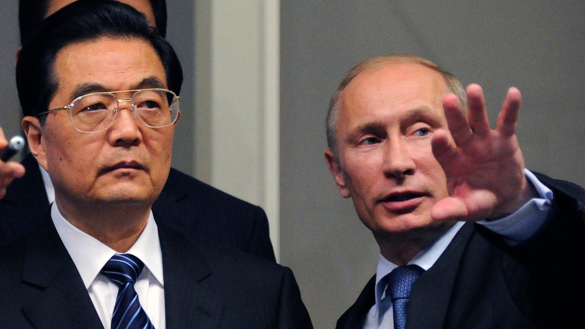  Russian Prime Minister Vladimir Putin, left, is shown with Chinese President Hu Jintao in 2011. (AP Photo/Alexander Nemenov, file) 