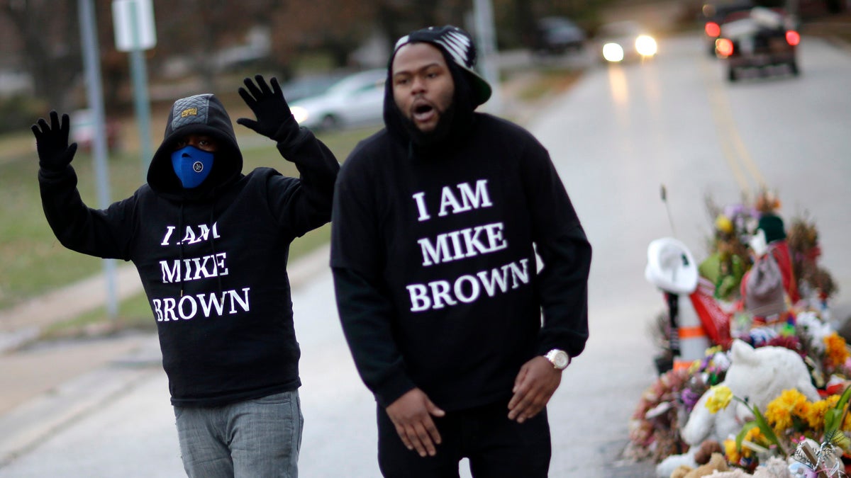  Protesters gather near a memorial in the middle of the street in Ferguson, Missouri, on Nov. 24, 2014, more than three months after a white policeman shot and killed Michael Brown, a black 18-year-old man, there. A grand jury later that night released its decision not to indict the the police officer. (AP Photo/David Goldman) 