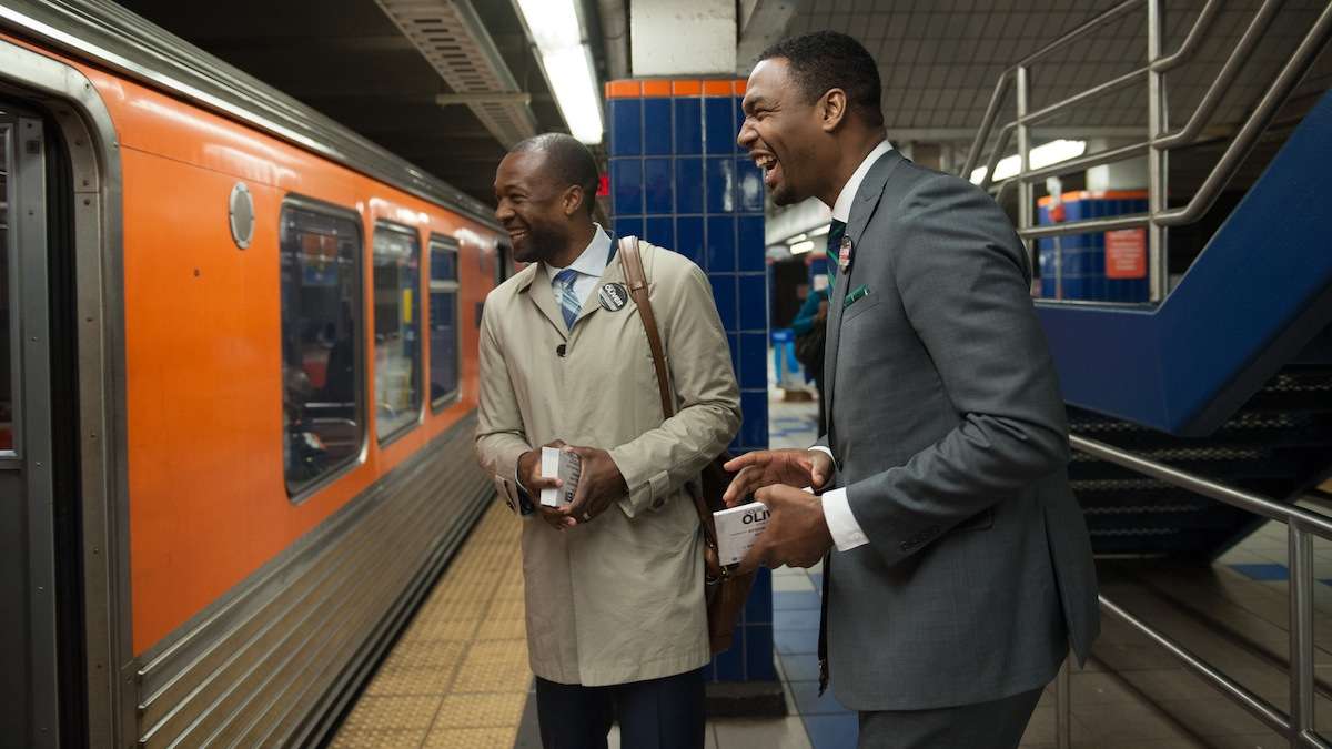  Doug Oliver and campaign spokesman Mustafa Rashed interact with voters on the Broad Street Line. (Tracie Van Auken/for NewsWorks) 