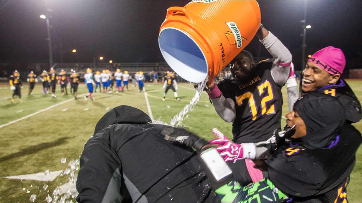  Coach Ed Dunn, shown here getting a celebratory dousing on the sidelines, has helmed MLK High's remarkable football revival this season. What other coaches in Northwest Philly warrant similar praise? (Brad Larrison/for NewsWorks) 