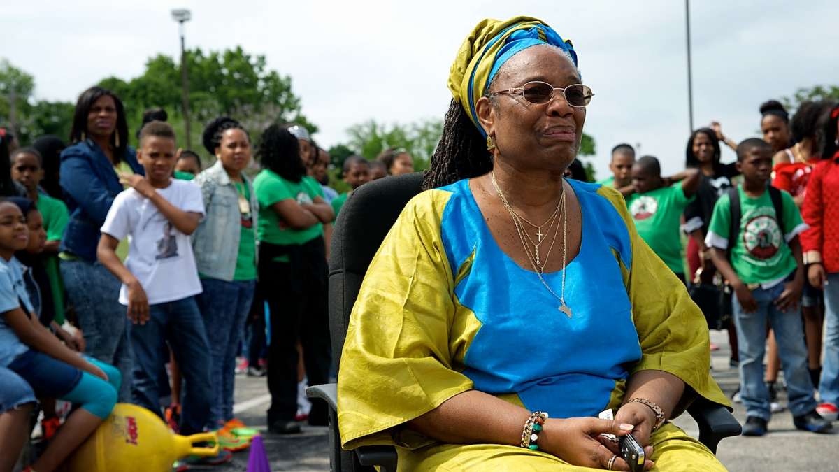  Imani CEO Dr. Francine Fulton sits back and enjoys the performances in her honor outside the Germantown charter school at a May celebration. (Bas Slabbers/for NewsWorks) 