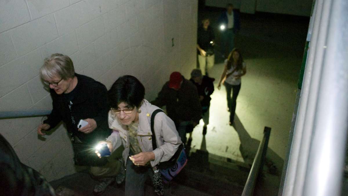  During a May open house at the shuttered Germantown High School building, visitors needed mobile-phone lights to navigate. (NewsWorks, file art) 