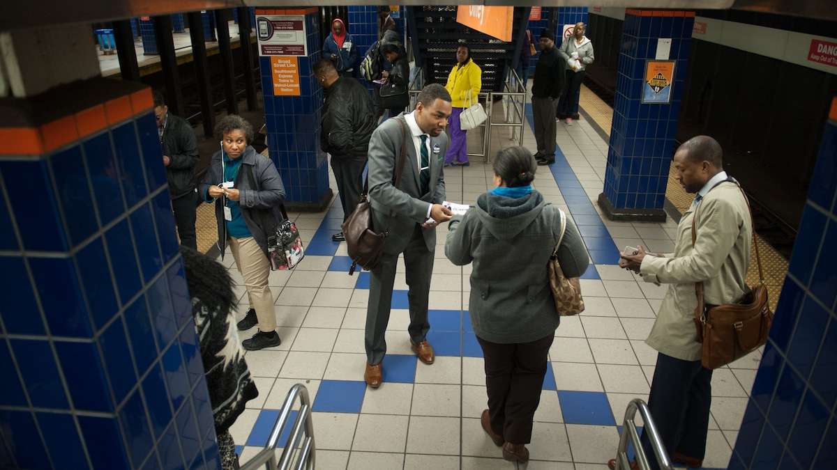  Mayoral candidate Doug Oliver (center) hands out flyers to Broad Street Line passengers at the Olney station. He has been campaigning on SEPTA trains and buses since January. (Tracie Van Auken/for NewsWorks) 