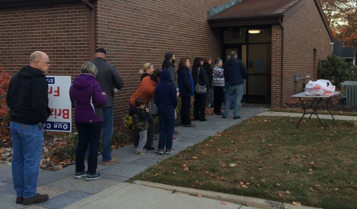 A line of voters in Langhorne, Bucks County, waits for their polling place to open. (Eugene Sonn/WHYY
