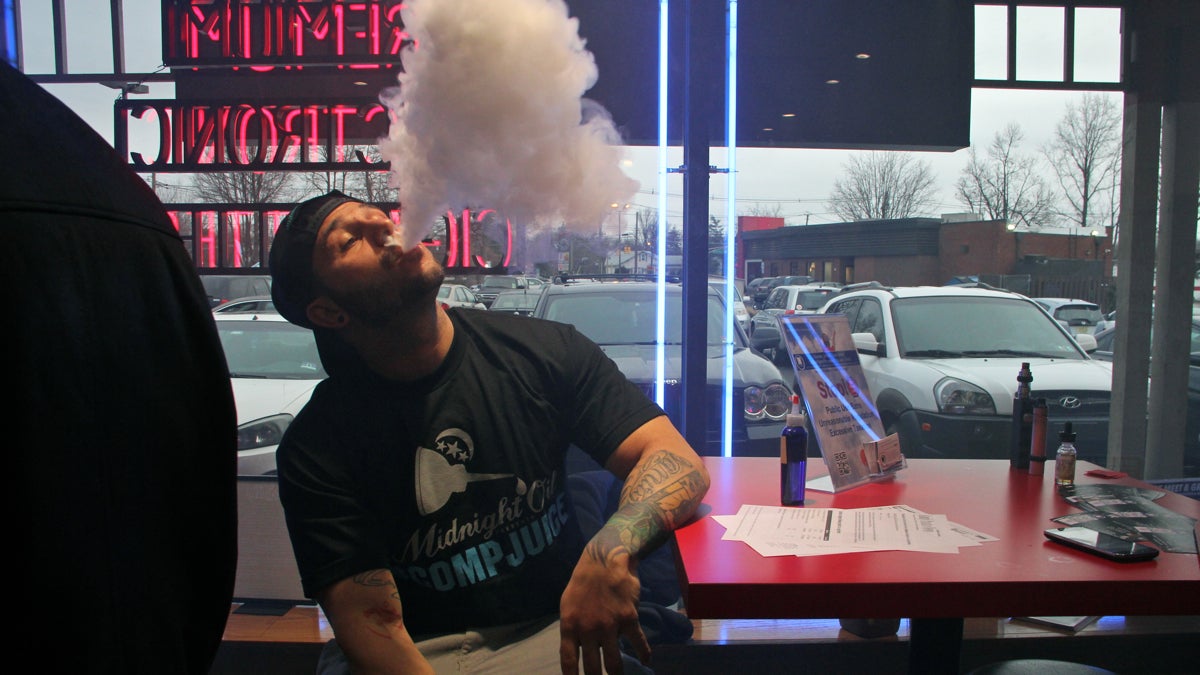 Matt Zarzycki of Upper Darby, Pa., enjoys a vape at Firehouse E-Cigs in Cherry Hill, N.J., where he and other vaping enthusiasts had gathered to learn how to advocate. (Emma Lee/WHYY)