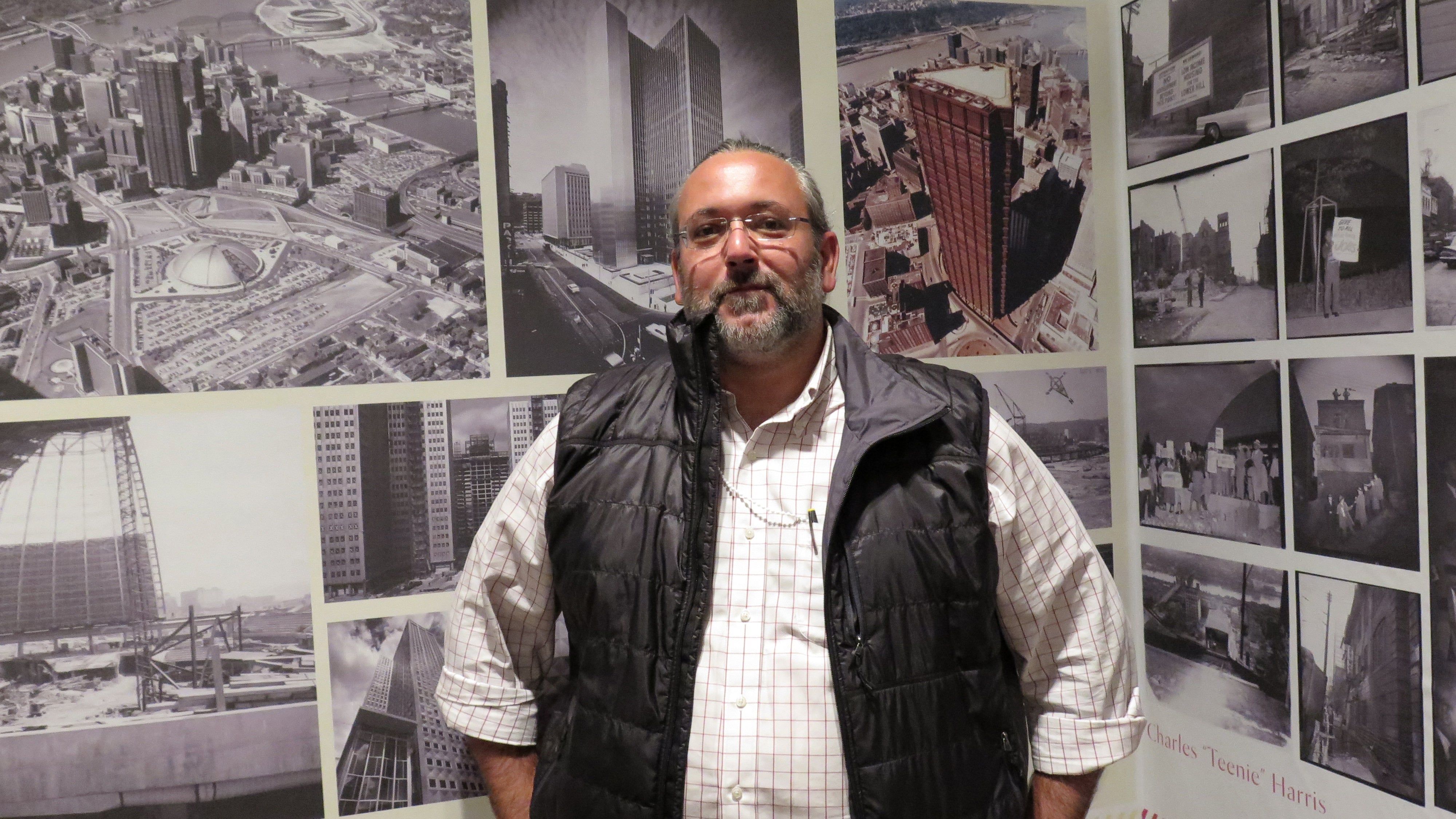  Rami el Samahy, who helped put together the Imagining the Modern exhibit at the Carnegie Museum of Art, with some of the show's archival photos. (Irina Zhorov/WESA) 