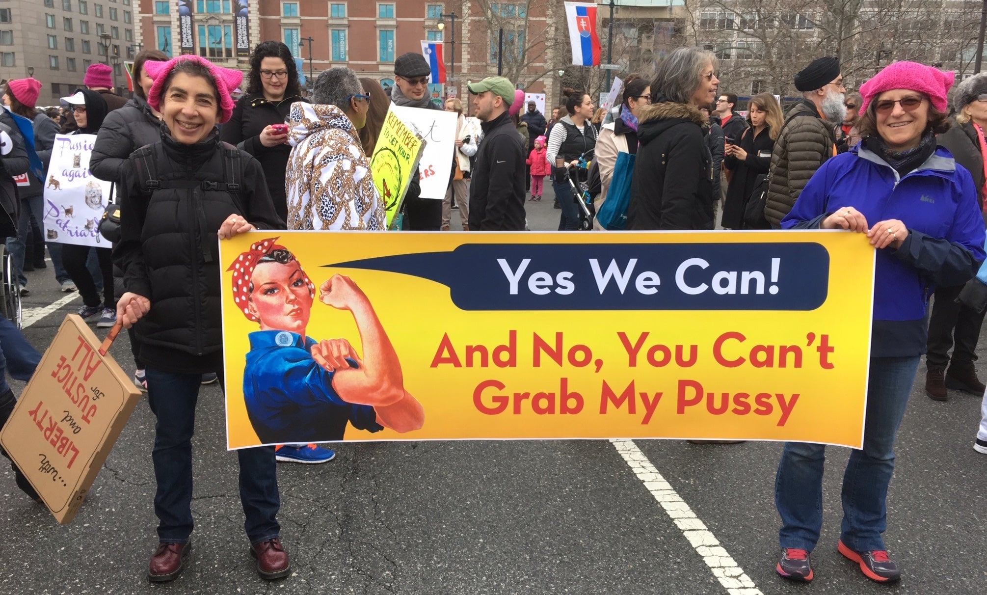 The author (left) is shown holding a sign with her partner Elissa Goldberg. (Image courtesy of Anndee Hochman)
