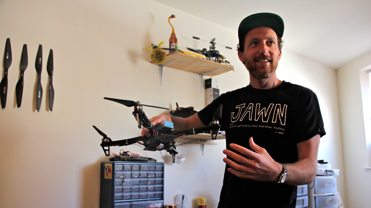  Maxwell Tubman of Steam Machine Pictures in South Philly holds one of his many copters. (Emma Lee/WHYY) 