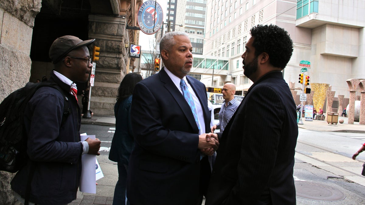  Mayoral candidate Tony Williams talks to campaign spokesman Al Butler outside the Reading Terminal Market on Tuesday. (Emma Lee/WHYY) 