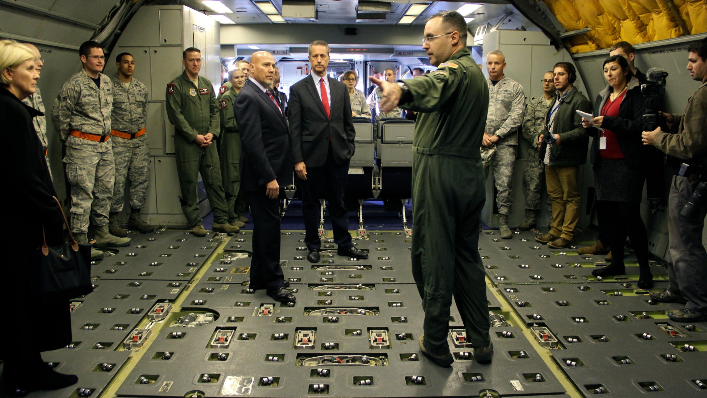 U.S. Rep. Tom MacArthur (center left) and U.S. Rep. Mac Thornberry (center), chairman of the Armed Services Committee,  tour a KC-10 aerial refueling plane at Joint Base McGuire-Dix-Lakehurst. (Emma Lee/WHYY) 