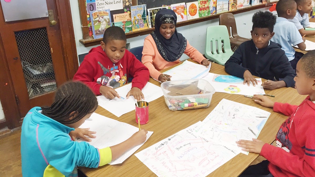  Students draw up their ideas for what they want to see on their playground. (Neema Roshania/WHYY) 