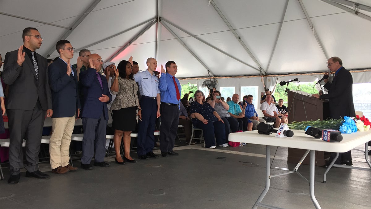 Thirty-nine South Jerseyans take the Oath of Allegiance to become U.S. citizens in a naturalization ceremony aboard the Battleship New Jersey. (Joe Hernandez/WHYY)