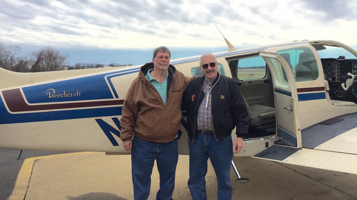 Michael Valdrighi (L) and William Moore ready to take off from Northeast Philadelphia Airport. (Neema Roshania Patel/WHYY)