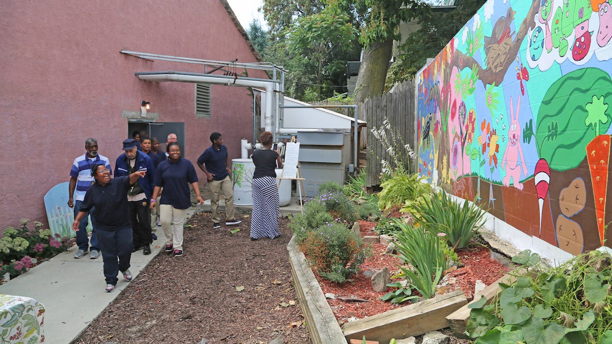 Students and elders seeing the complete mural and the garden for the first time (Natavan Werbock/for NewsWorks)