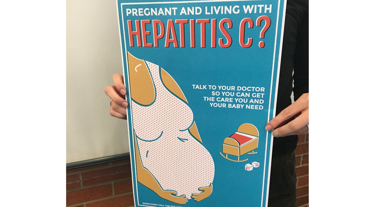  Danica Kuncio, hepatitis epidemiologist for the city of Philadelphia, holds an outreach sign aimed at pregnant woman with hepatitis C. (Elana Gordon/WHYY) 