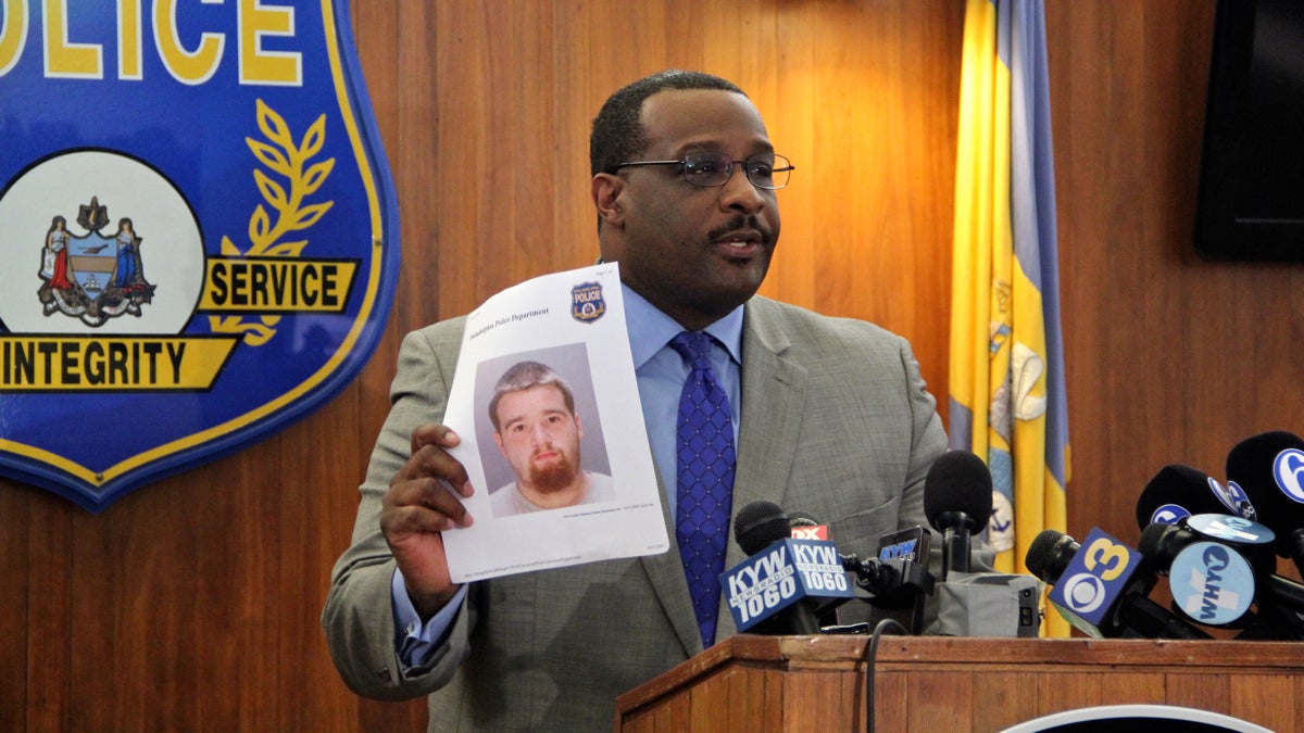  Philadelphia Homicide Unit Capt. James B. Clark Jr. holds a photo of Pedro Redding, charged with murder in the shooting death of Kiesha Jenkins. Clark said other suspects were involved and Redding was not the triggerman. (Emma Lee/WHYY) 