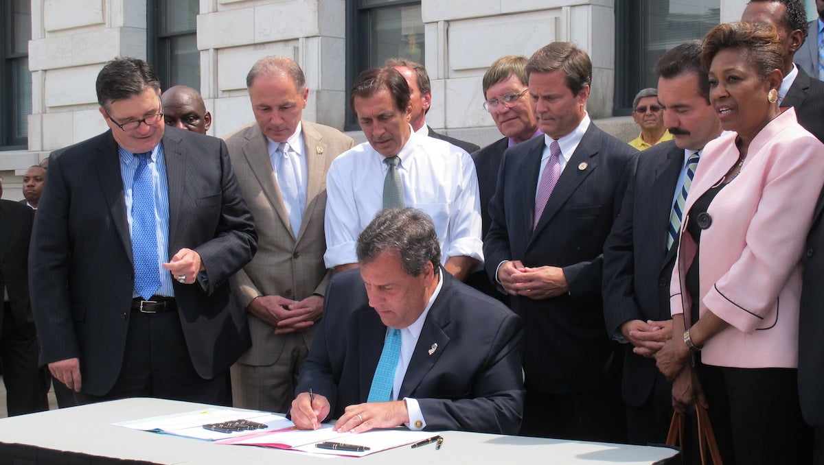  Governor Chris Christie signs bail reform legislation in a ceremony onthe steps of Trenton's City Hall / Phil Gregory 