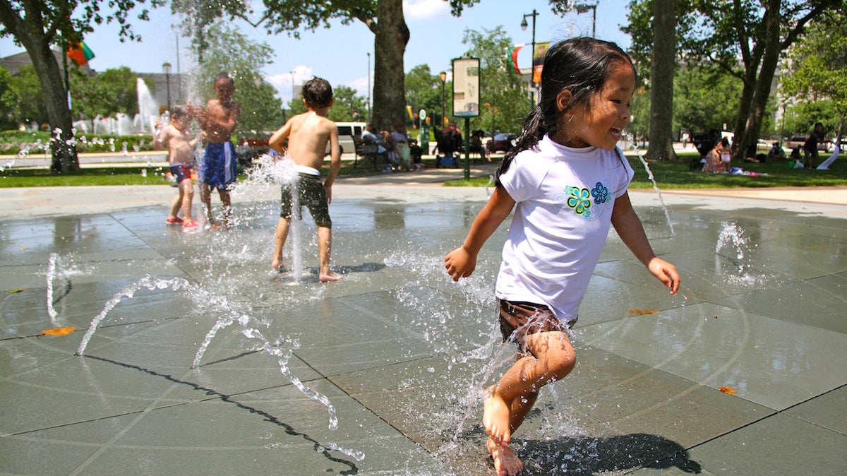 Cooling off at a sprayground (Emma Lee/WHYY)