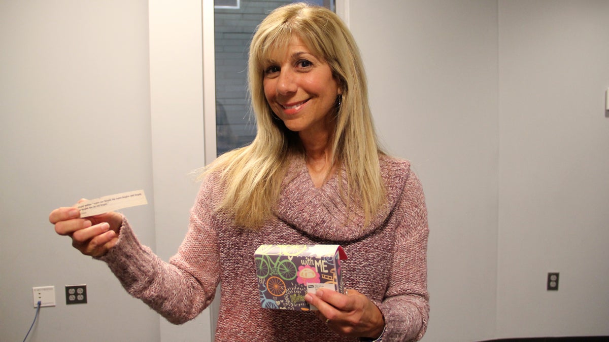 Ann Marie Wiesen draws strength from the box of encouraging sayings she carries with her. (Emma Lee/WHYY)