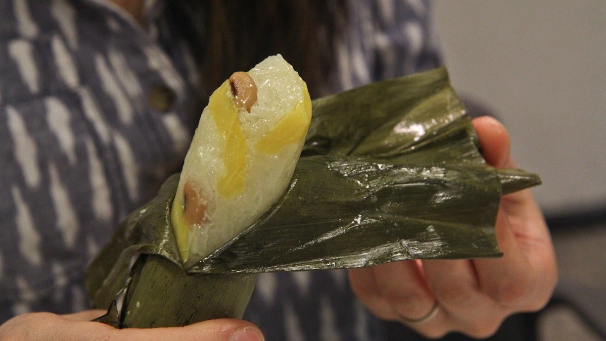  Num asom is a coconut infused sticky rice with plantain, jackfruit and black eyed peas steamed in banana leaves. (Kimberly Paynter/WHYY) 