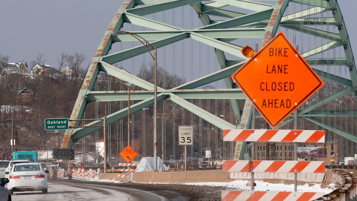 File photo: In this photo made on Thursday, Feb. 19, 2015, a lane is blocked by construction equipment as work continues on the Birmingham Bridge that spans the Monongahela River in Pittsburgh. (AP Photo/Keith Srakocic) 