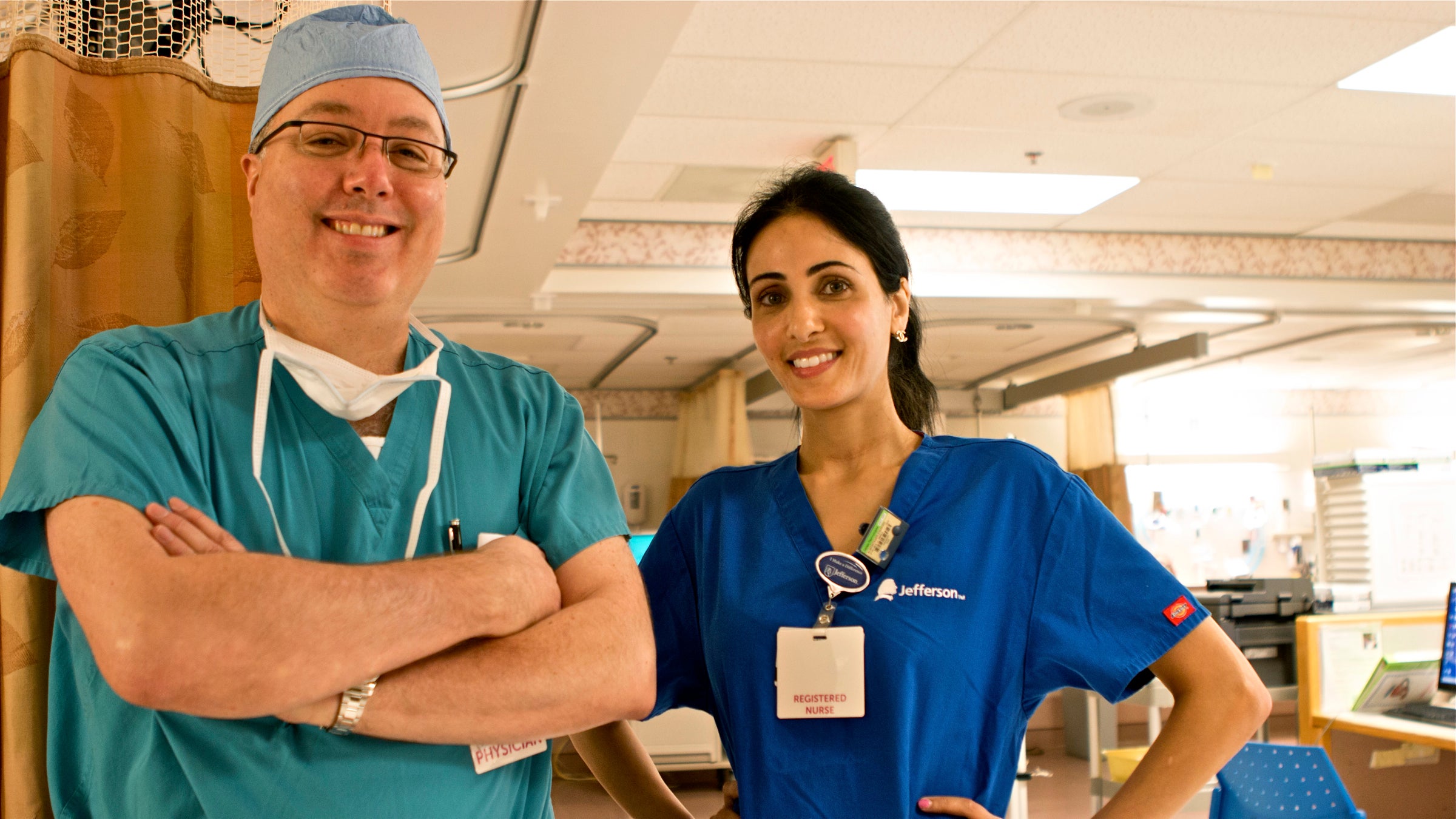 Dr. James Heitz, seen here with nurse Esmihan Almontaser, says crying after anesthesia occurs frequently enough that 'we should be aware of it as providers' even though it's not frequently documented in major anesthesiology textbooks (Karen Shakerdge/for WHYY)