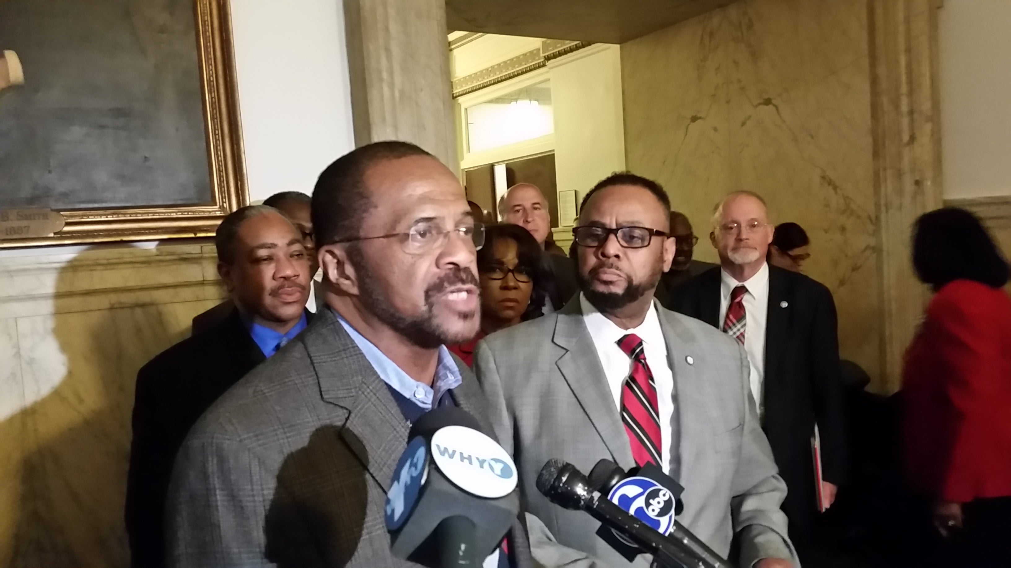  Philadelphia Sheriff Jewell Williams, at podium, talks about scammers saying they represent his office. Councilman Curtis Jones, right, says his constituents have gotten some of the bogus calls. (Tom MacDonald/WHYY) 