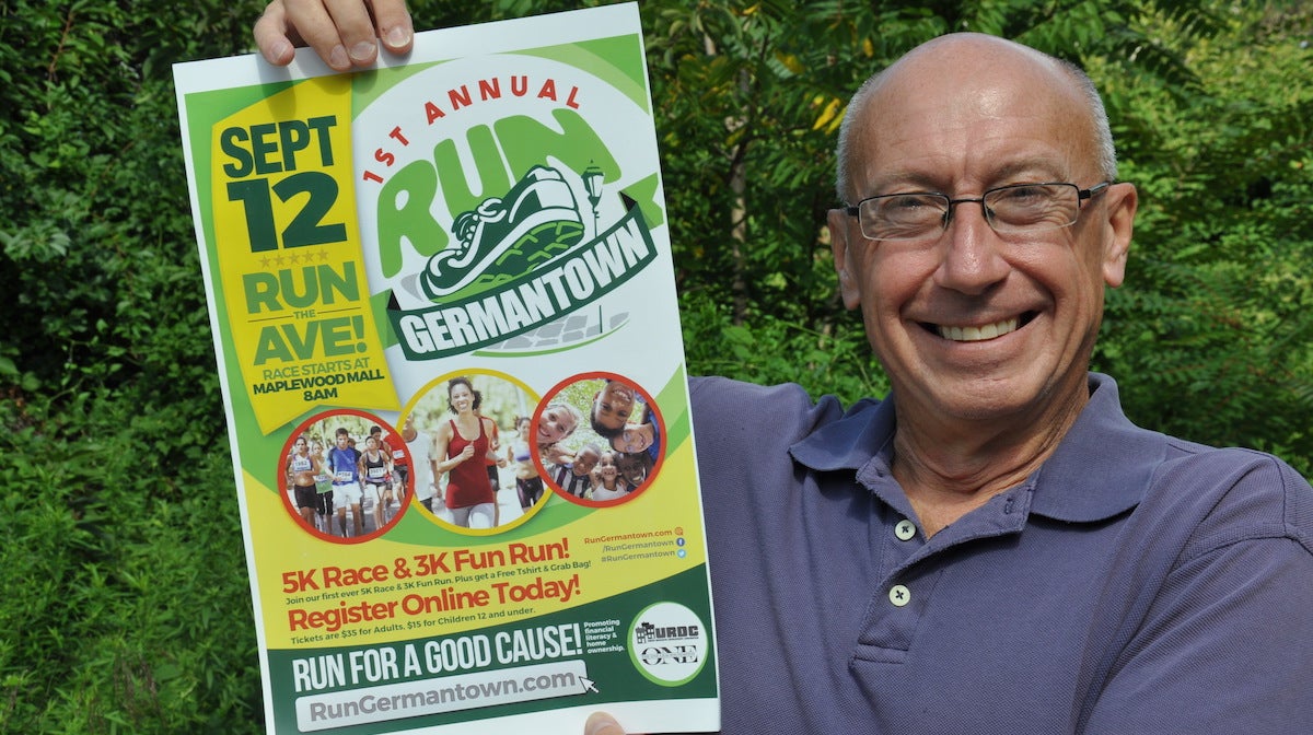  Joe Waldo holds up a poster for Run Germantown. (Greta Iverson/for NewsWorks) 