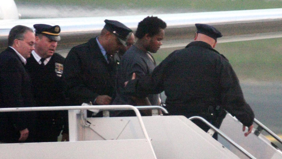  Law enforcement officers are shown escorting John Jordan Lewis from an airplane in Philadelphia, on Friday Nov. 9, 2007. Wanted for the shooting death of Philadelphia police officer Chuck Cassidy, he had fled for Miami. Having been convicted of murder, he was sentenced to death, and Gov. Tom Corbett has signed his death warrant. (AP Photo/ Joseph Kaczmarek) 