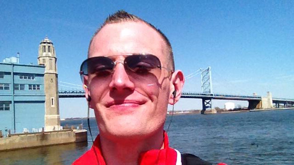  The author poses with the Benjamin Franklin Bridge in the background. (Image courtesy of Josh Kruger) 