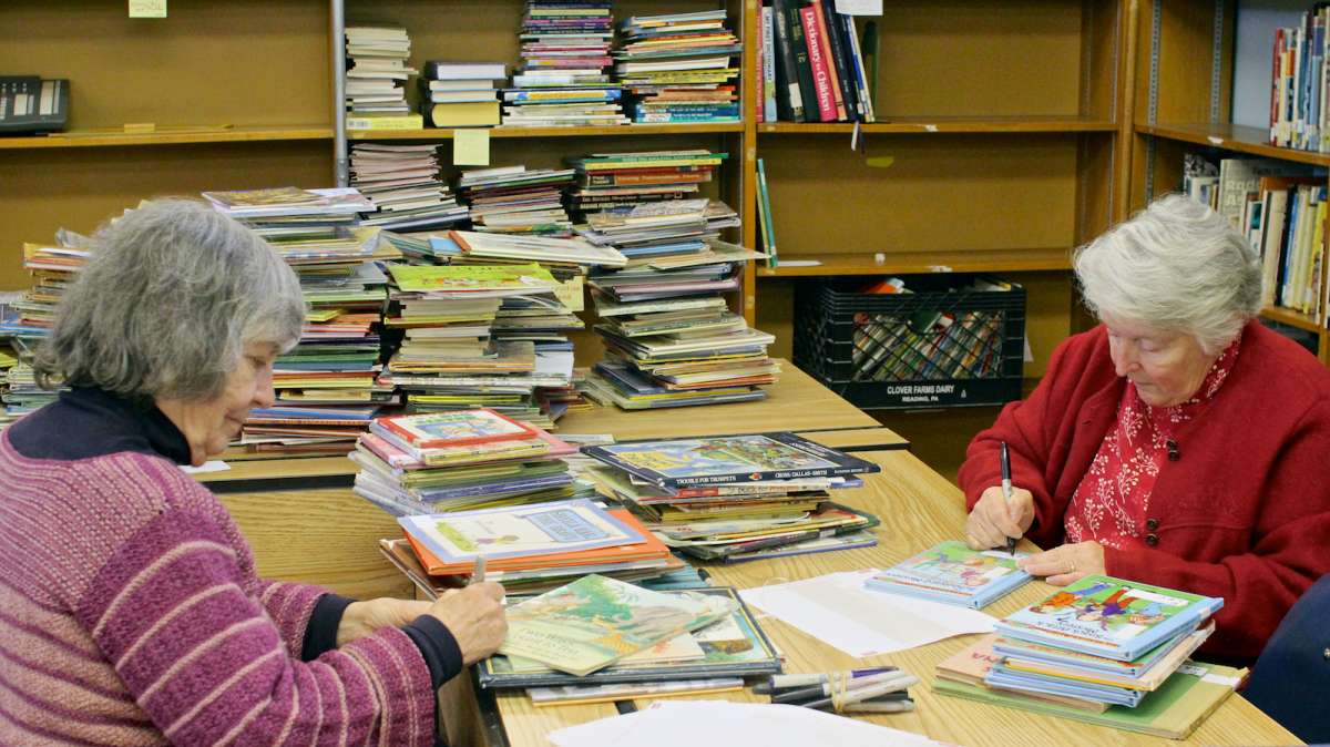  Neighborhood volunteers help sort, classify and label incoming book donations. (Jana Shea/for NewsWorks, file) 