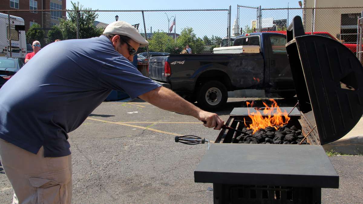  Sean Sullivan of Local 22 demonstrates the danger of using too much lighter fluid. (Emma Lee/WHYY) 