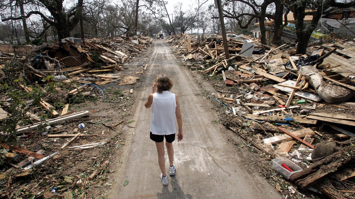 Rhonda Braden walks through the destruction in her childhood neighborhood