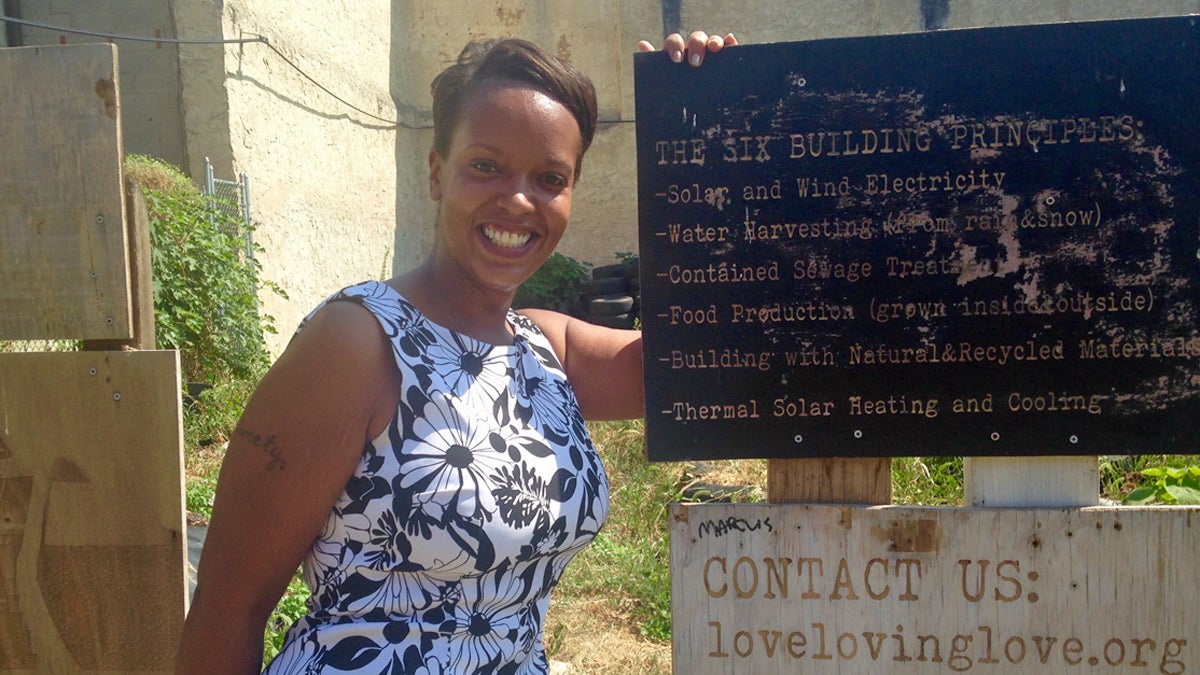  Rashida Ali-Campbell stands next to the Earthship sign in West Philly (Katie Hiler for NewsWorks) 