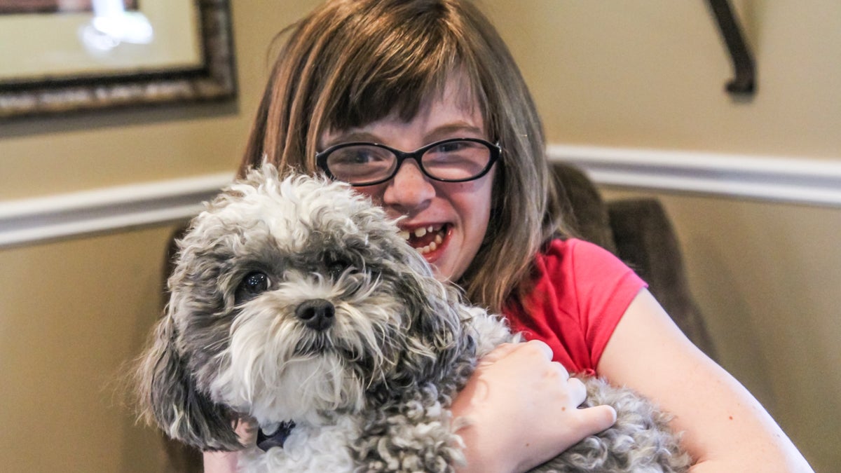 Katie Hassell and her dog Oliver at their home. (Kimberly Paynter/WHYY)