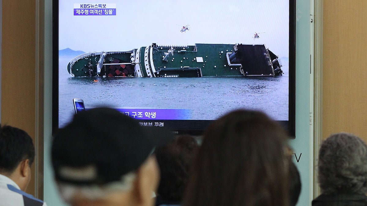  People watch a TV news program showing a sinking passenger ship, at Seoul Railway Station in Seoul, South Korea, Wednesday, April 16, 2014. The South Korean passenger ship carrying more than 470 people, including many high school students, is sinking off the country's southern coast Wednesday after sending a distress call, officials said. There are no immediate reports of causalities.(AP Photo/Ahn Young-joon)  