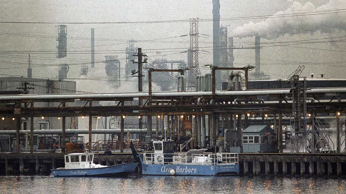  Two clean harbor cleanup boats work in the Arthur Kill waterway in 1990 in front of the Exxon oil refinery in Linden, New Jersey (AP Photo/Mike Derer) 