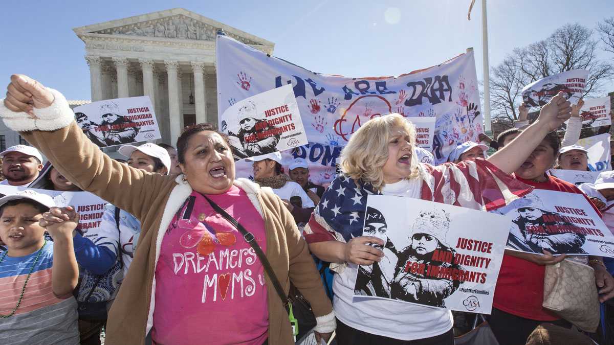 Immigration activists demonstrate at the Supreme Court in Washington earlier this year in support of President Barack Obama's executive order to grant relief from deportation in order to keep immigrant families together. (AP Photo/J. Scott Applewhite)