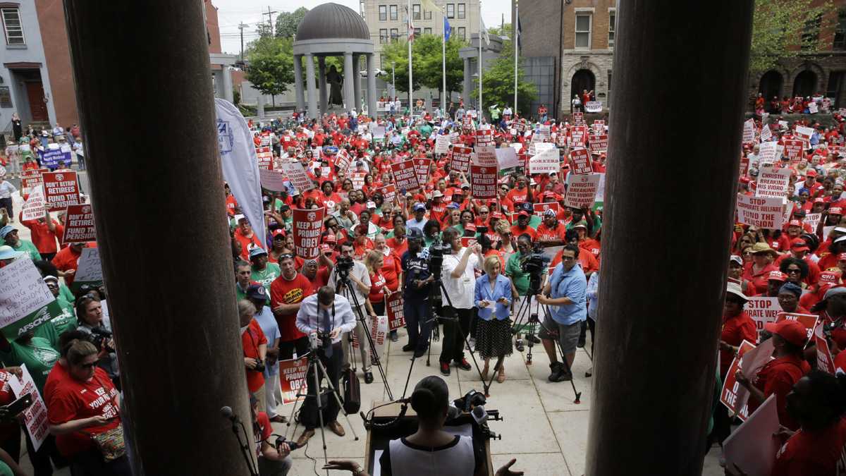  A large crowd of public employee union members fill the plaza and street in front of the Statehouse during a May protest in Trenton, New Jersey. They were protesting Gov. Chris Christie's pension-funding reductions. (AP file photo) 