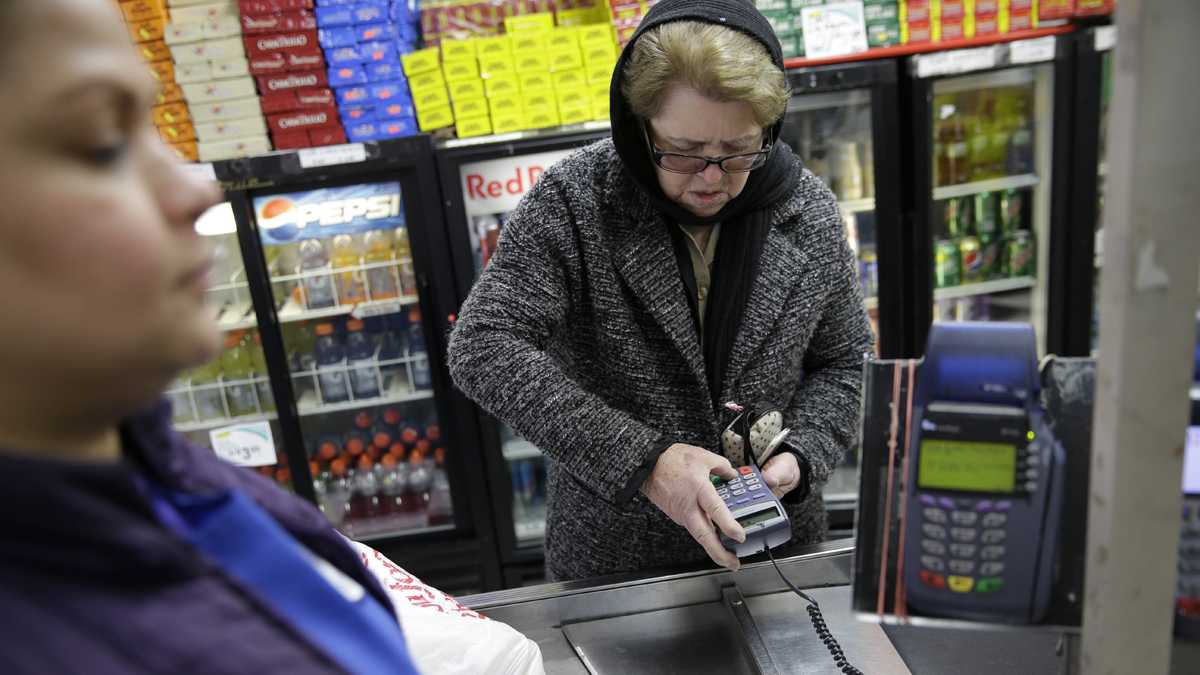 A woman pays for her groceries using state assistance at a supermarket (Seth Wenig/AP Photo)
