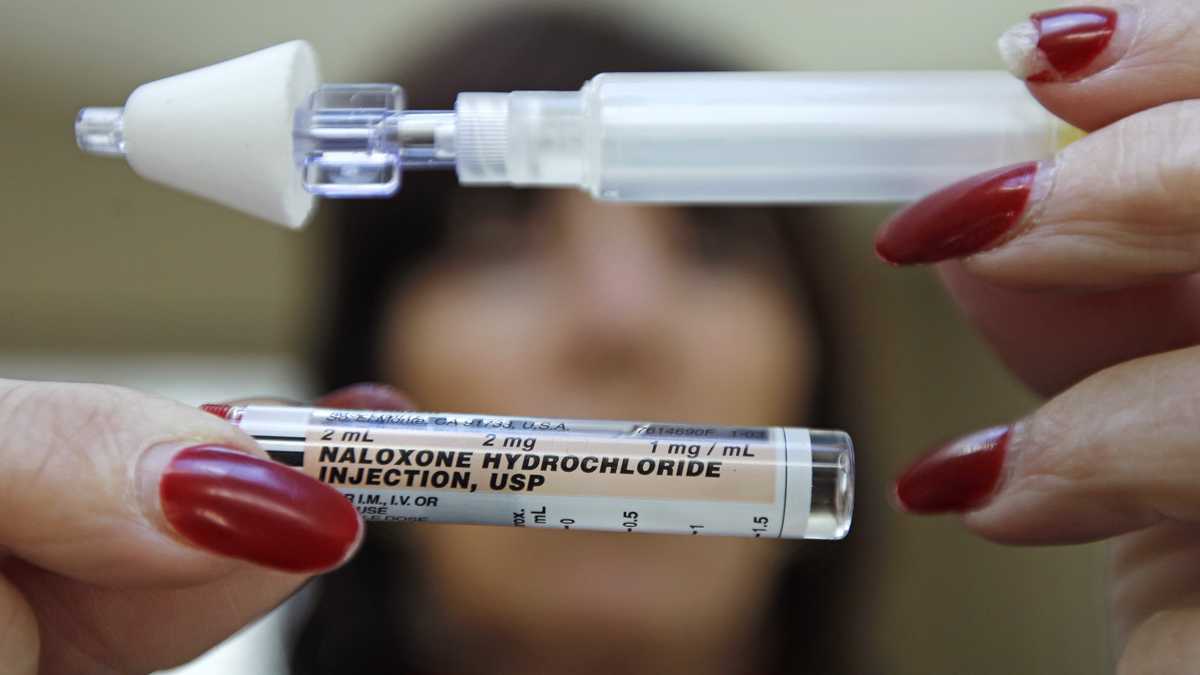  A woman holds up a tube of naloxone hydrochloride, also known as Narcan -- a nasal spray used as an antidote for opiate drug overdoses. (Charles Krupa/AP Photo, file) 