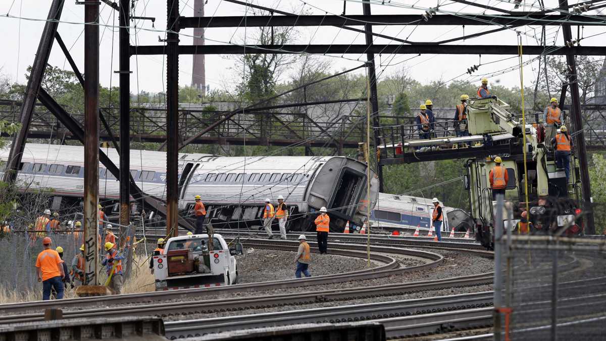  Emergency personnel walk near the scene of a deadly train wreck, Wednesday, May 13, 2015, in Philadelphia. (Mel Evans/AP Photo) 
