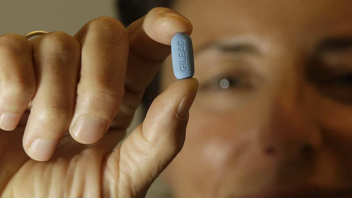 Dr. Lisa Sterman holds up a Truvada pill at her office in San Francisco. The pill
