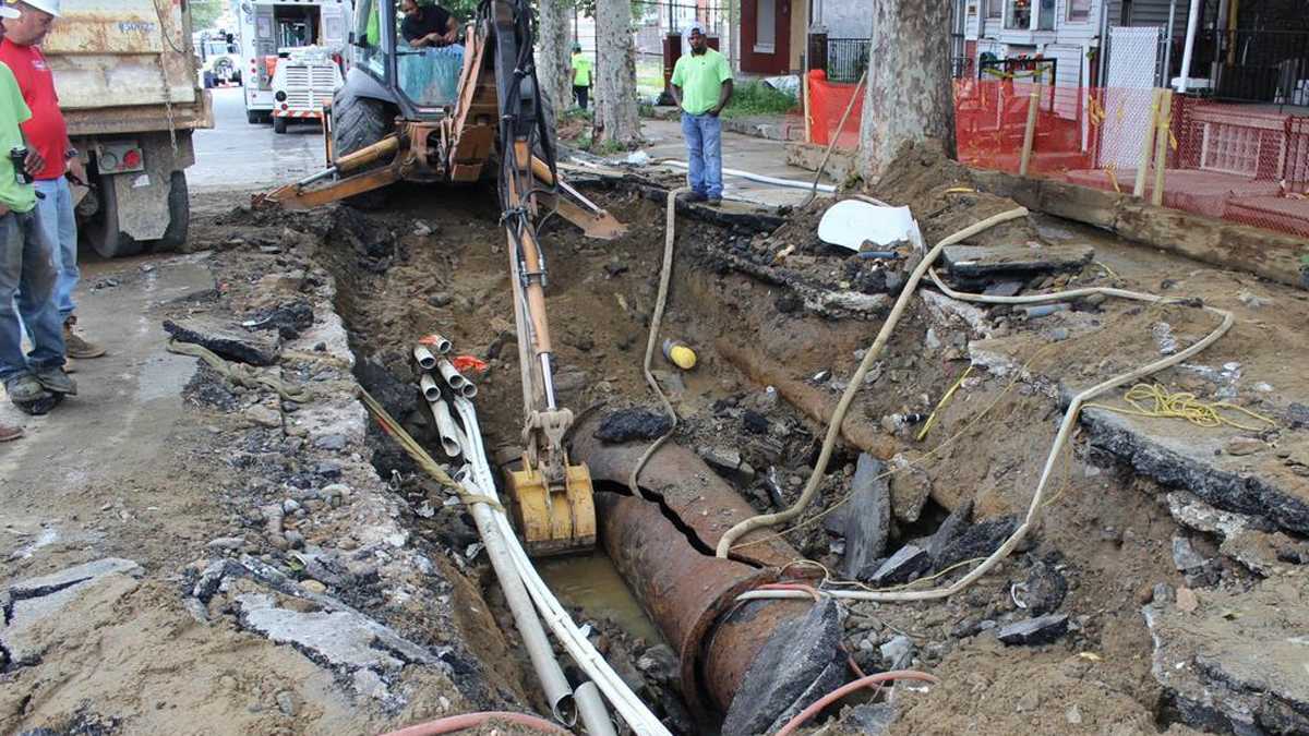  Workers look over the broken main that caused widespread flooding in West Philadelphia. The Water Department is posting updates on the burst main. (Philadelphia Water Department) 