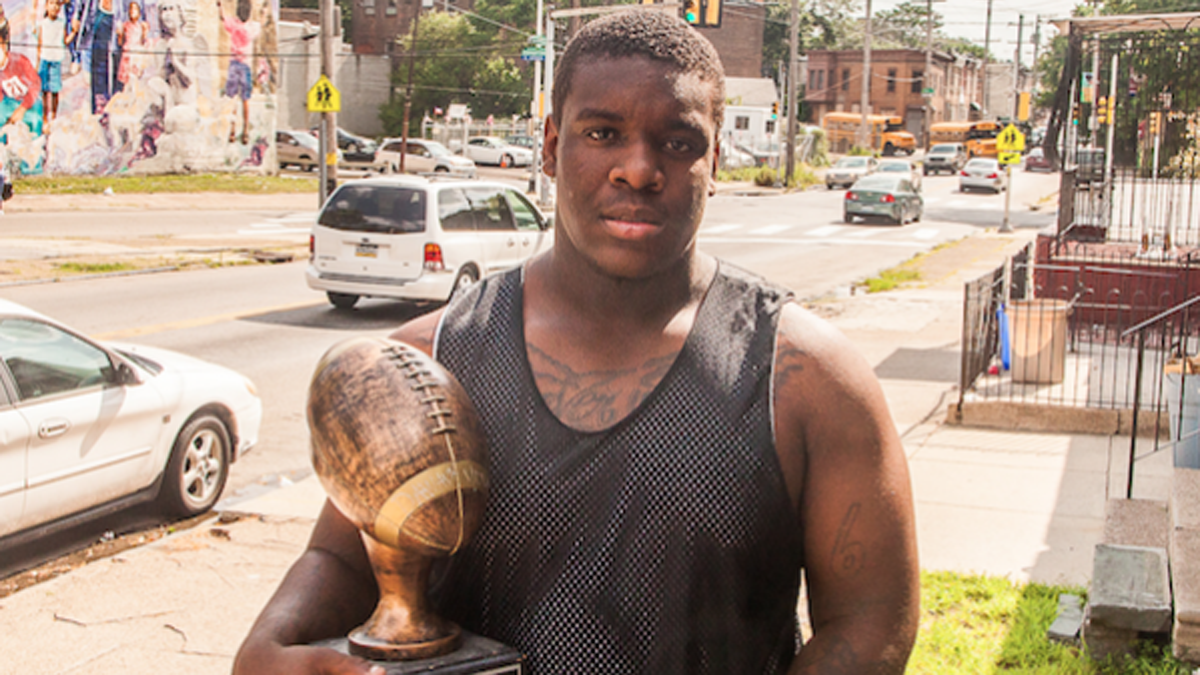  Dawayne Young holds a trophy he received for being the top overall performer at the Next Level Nation Football Camp. (Brad Larrison/for NewsWorks) 