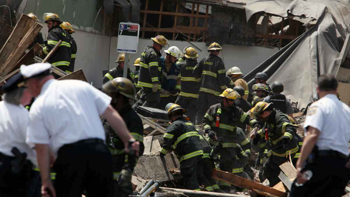 Rescue personnel search the scene of the building collapse in downtown Philadelphia on June 5. (AP Photo/Jacqueline Larma)